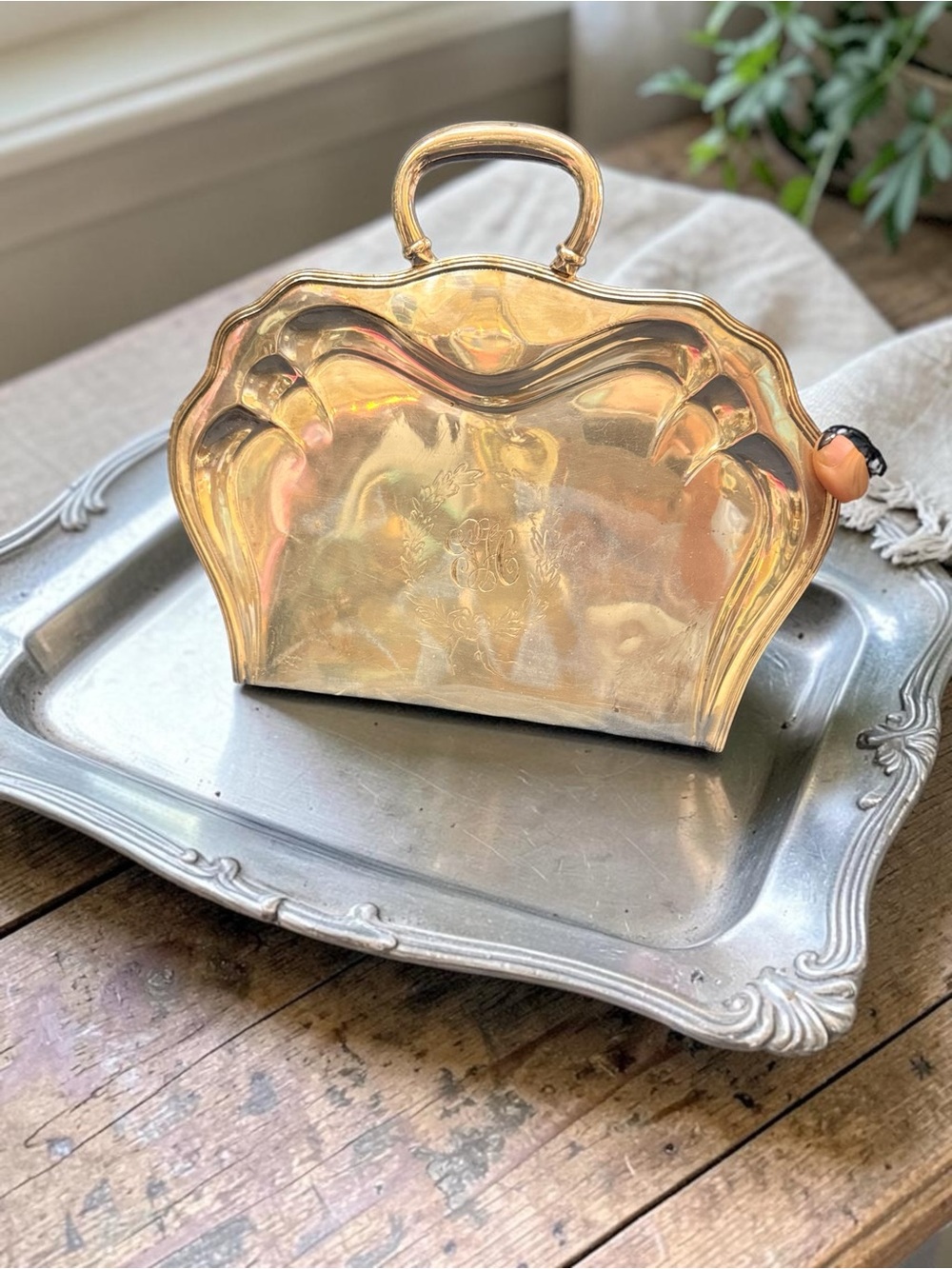 Antique silver-plated silent butler crumb catcher with monogram.